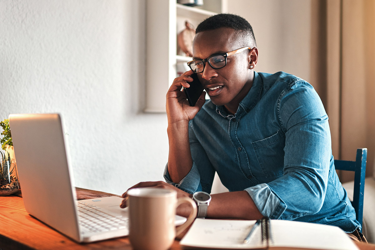 man on phone and laptop